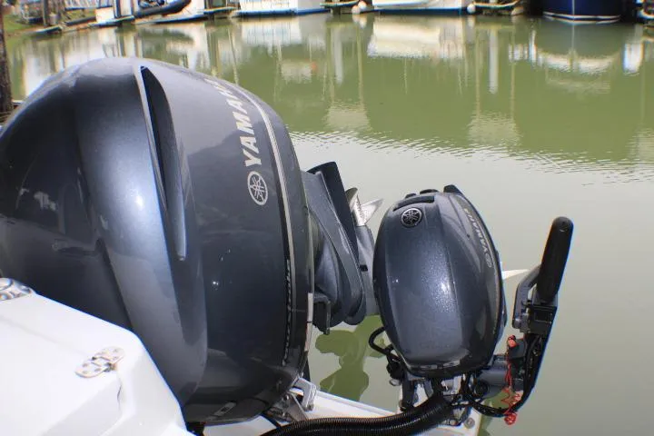 Slide: The Image of Yamaha outboard motors on a 2020 Ranger Tugs R-27 boat by the water. - 11