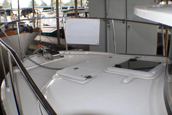 Slide: The Image of 2020 Ranger Tugs R-27 boat deck with railing and hatch in marina. - 16