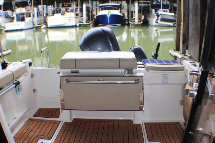 Slide: The Image of 2020 Ranger Tugs R-27 boat interior with seating, docked at marina. - 26