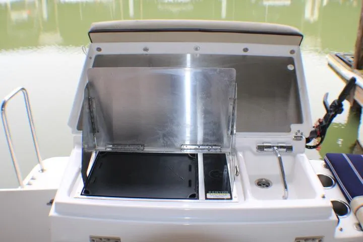 Slide: The Image of Outdoor kitchen on 2020 Ranger Tugs R-27 boat with grill and sink. - 28