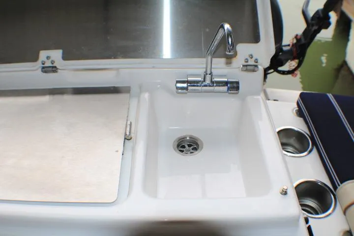 Slide: The Image of 2020 Ranger Tugs R-27 boat sink with faucet and cup holders. - 29