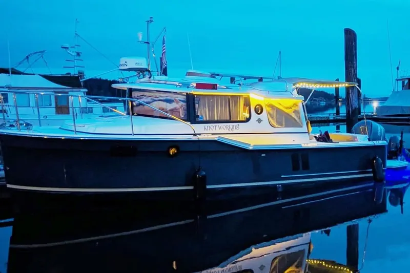 Slide: The Image of 2020 Ranger Tugs R-27 boat docked at marina during twilight. - 3