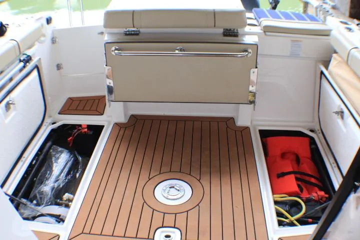 Slide: The Image of 2020 Ranger Tugs R-27 boat interior with storage compartments and teak flooring. - 34