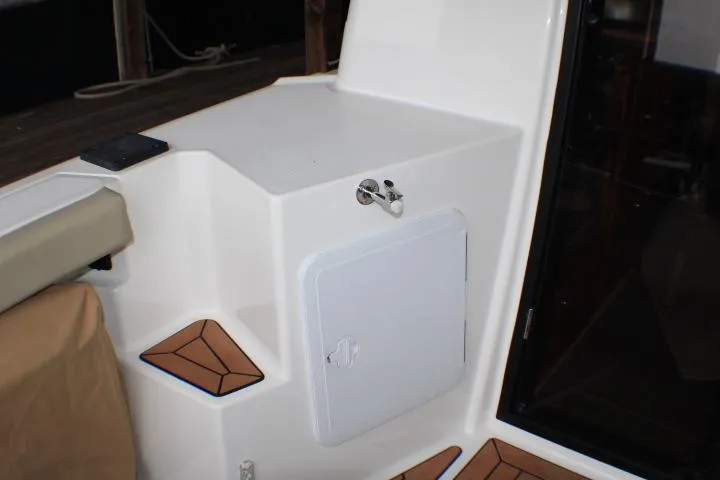 Slide: The Image of 2020 Ranger Tugs R-27 boat interior with storage compartment and teak accents. - 37