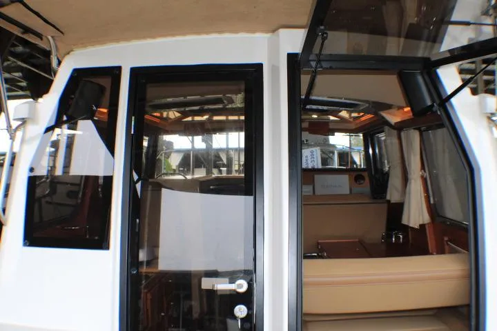 Slide: The Image of 2020 Ranger Tugs R-27 interior view with open cabin door. - 40