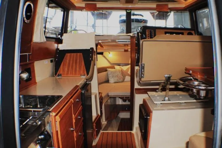Slide: The Image of Interior of 2020 Ranger Tugs R-27 boat, featuring cozy cabin and modern amenities. - 42