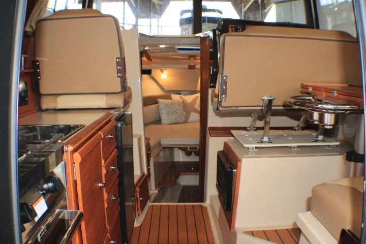Slide: The Image of Interior of 2020 Ranger Tugs R-27 boat, featuring cozy cabin and wooden finishes. - 43