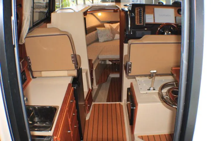 Slide: The Image of Interior of 2020 Ranger Tugs R-27 boat, featuring cozy seating and wooden flooring. - 44