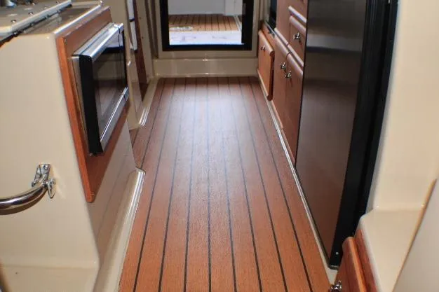 Slide: The Image of Interior of 2020 Ranger Tugs R-27 boat with wood flooring and cabinetry. - 46