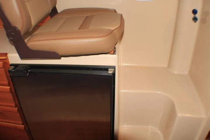 Slide: The Image of Interior of 2020 Ranger Tugs R-27 with seat and compact fridge. - 57