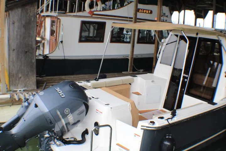 Slide: The Image of 2020 Ranger Tugs R-27 boat with Yamaha 300 engine, docked in a marina. - 6