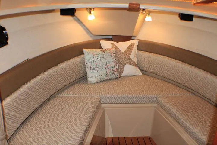 Slide: The Image of Cozy interior of 2020 Ranger Tugs R-27 with patterned cushions and decorative pillows. - 74