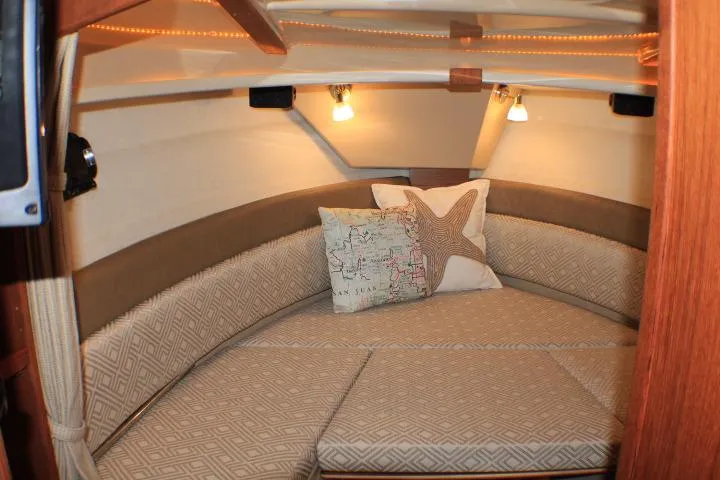 Slide: The Image of Cozy interior of 2020 Ranger Tugs R-27 boat with cushions and decorative pillows. - 75