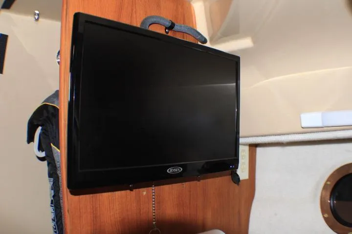 Slide: The Image of Flat-screen TV inside 2020 Ranger Tugs R-27 boat cabin, mounted on wooden panel. - 80