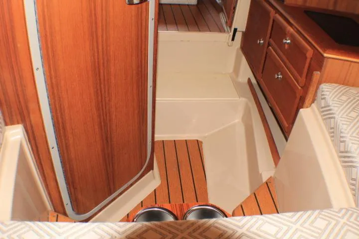 Slide: The Image of Interior of 2020 Ranger Tugs R-27 boat with wood finish and storage drawers. - 82