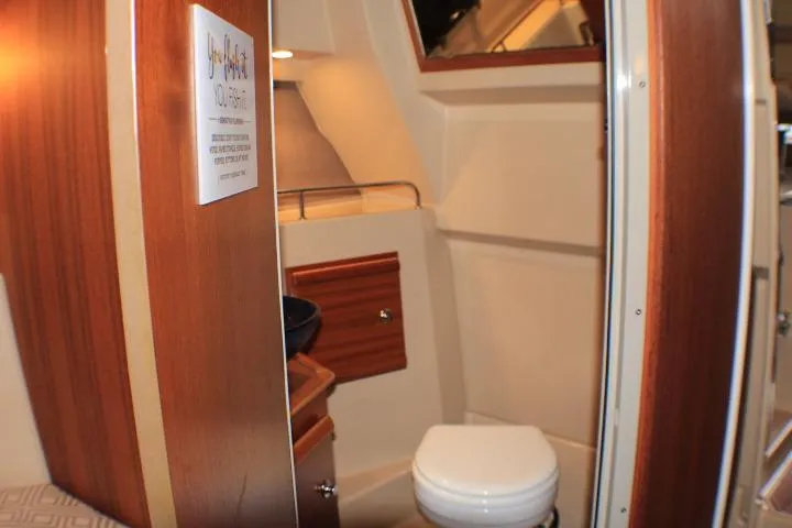 Slide: The Image of Interior of 2020 Ranger Tugs R-27 boat featuring a compact bathroom. - 84