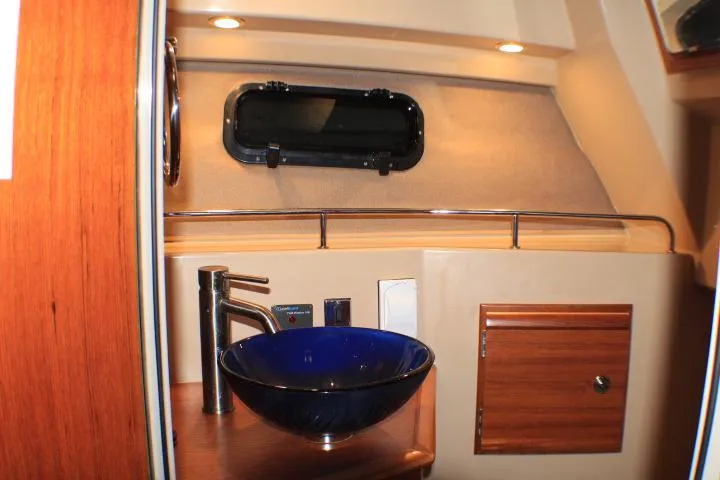 Slide: The Image of 2020 Ranger Tugs R-27 interior with modern sink and wooden cabinetry. - 85