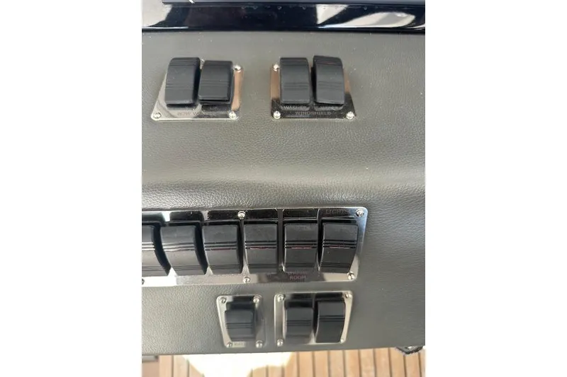 Slide: The Image of Control panel of a 2023 Schaefer 400 yacht with multiple switches. - 33