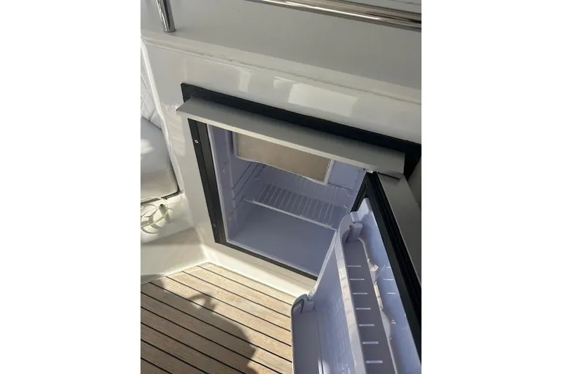 Slide: The Image of Open refrigerator on Schaefer 400 yacht, 2023 model, with wooden deck flooring. - 35