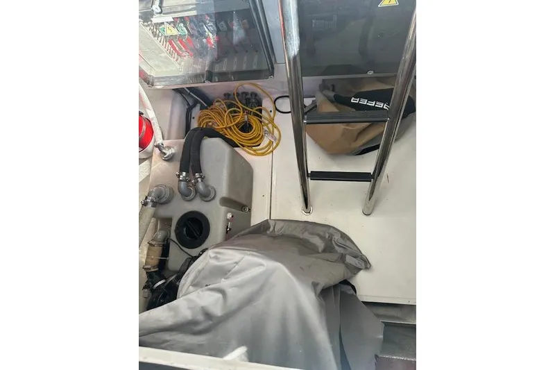 Slide: The Image of Interior view of a 2023 Schaefer 400 boat, featuring equipment and storage. - 36