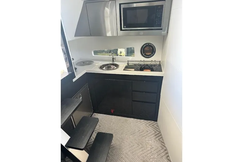 Slide: The Image of Compact kitchen in 2023 Schaefer 400 yacht with modern appliances and sleek design. - 38