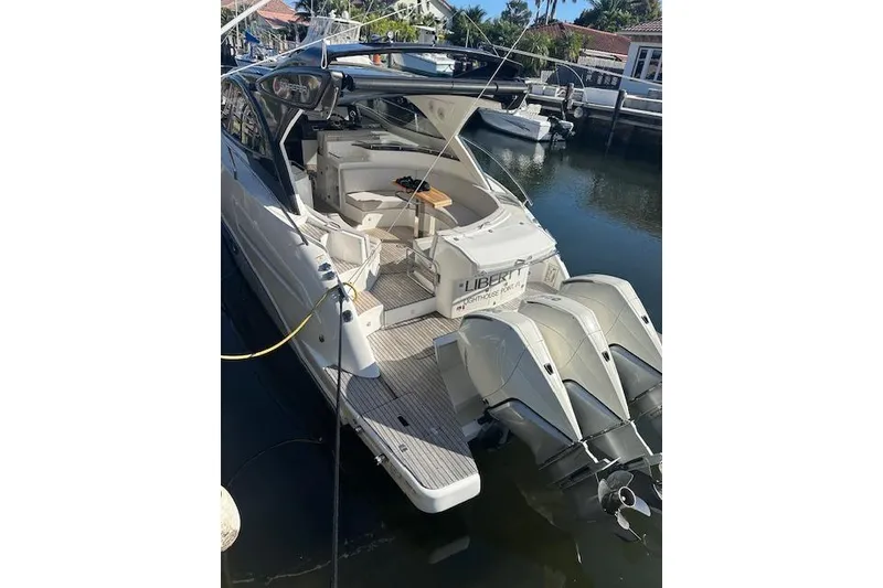 Slide: The Image of 2023 Schaefer 400 yacht docked, featuring triple outboard engines and spacious deck area. - 48