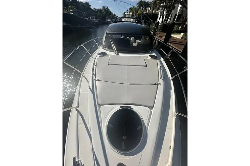 Slide: The Image of 2023 Schaefer 400 yacht on a sunny canal, showcasing sleek deck design. - 55