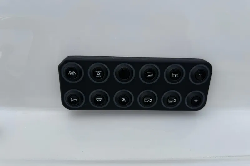 Slide: The Image of Control panel of 2026 Blazer PureBay 2200 boat with multiple switches. - 18