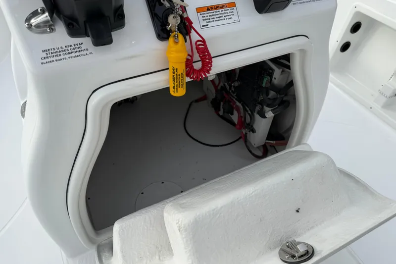 Slide: The Image of 2026 Blazer PureBay 2200 boat console with open storage compartment and safety features. - 22