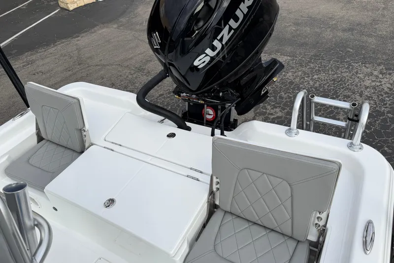 Slide: The Image of 2026 Blazer PureBay 2200 boat with Suzuki outboard motor and gray seating. - 27