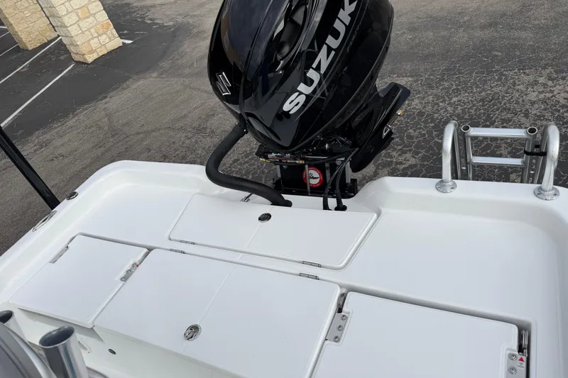 Slide: The Image of 2026 Blazer PureBay 2200 boat with Suzuki outboard motor, rear deck view. - 28