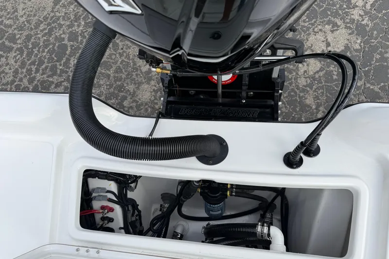 Slide: The Image of 2026 Blazer PureBay 2200 boat engine compartment with visible wiring and components. - 30