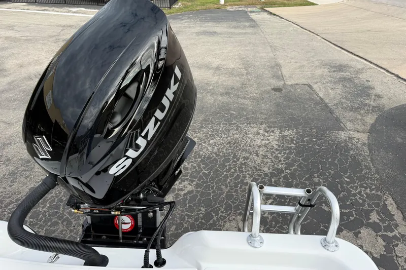 Slide: The Image of 2026 Blazer PureBay 2200 with Suzuki outboard motor on a paved surface. - 31