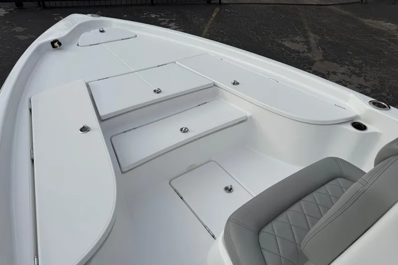 Slide: The Image of 2026 Blazer PureBay 2200 boat interior with white seating and storage compartments. - 33
