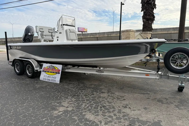 Slide: The Image of 2026 Blazer PureBay 2200 boat on trailer, displayed outdoors. - 47