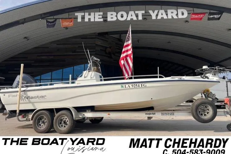 The Image of 2003 Fishmaster 2300 boat on trailer at The Boat Yard, Louisiana, with American flag. - 0