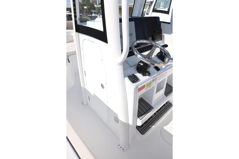 Slide: The Image of 2026 Sea Hunt Ultra 245 SE boat helm with steering wheel and controls. - 11