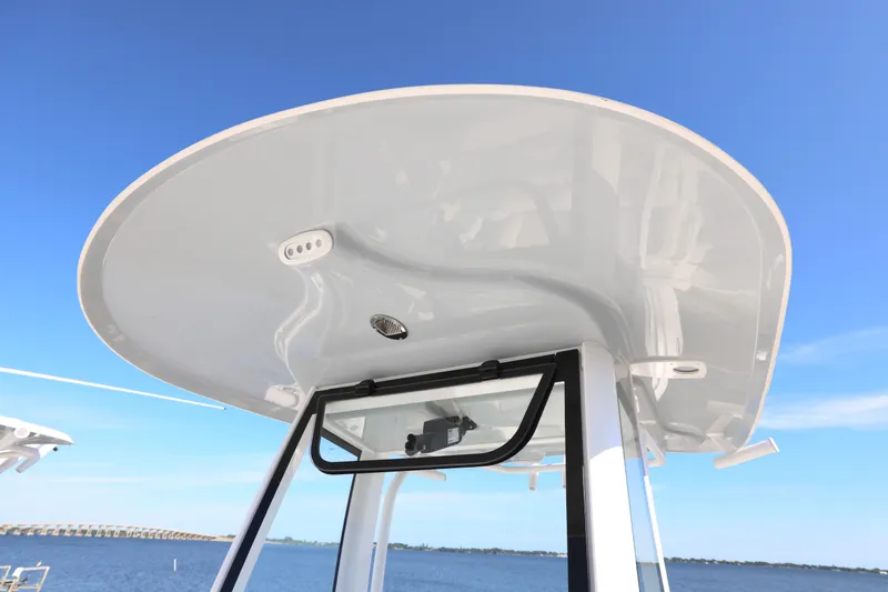 Slide: The Image of 2026 Sea Hunt Ultra 245 SE boat's T-top against clear blue sky. - 12