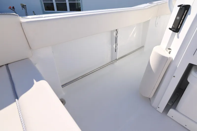 Slide: The Image of Interior view of 2026 Sea Hunt Ultra 245 SE boat, featuring sleek white seating. - 14
