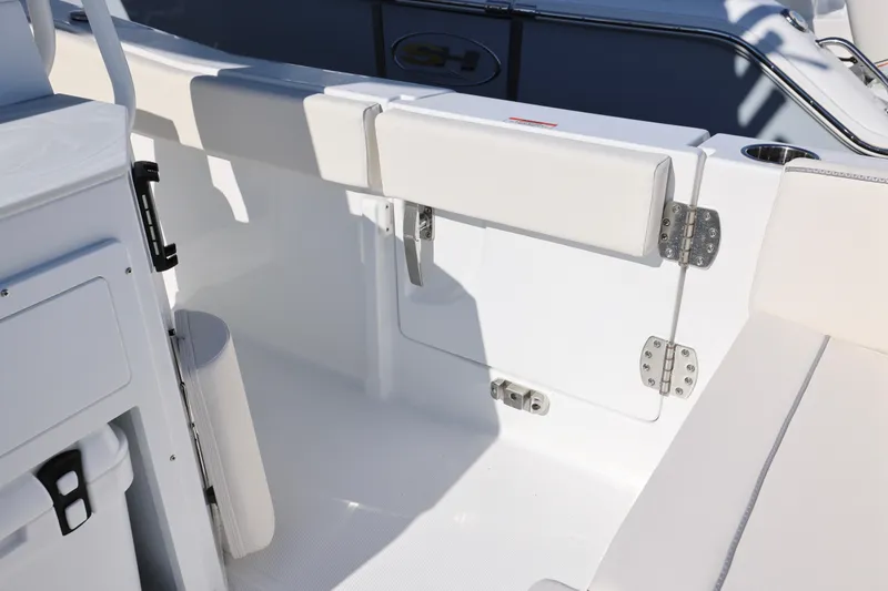 Slide: The Image of 2026 Sea Hunt Ultra 245 SE boat interior with white seating and storage compartments. - 17
