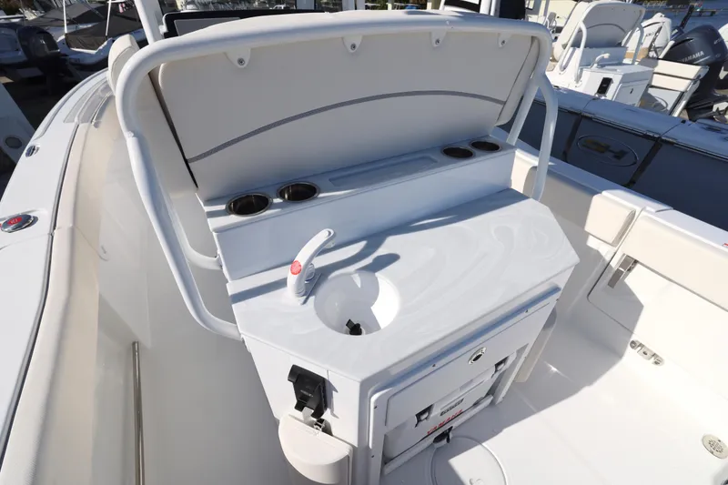 Slide: The Image of 2026 Sea Hunt Ultra 245 SE boat interior with sink and storage area. - 18