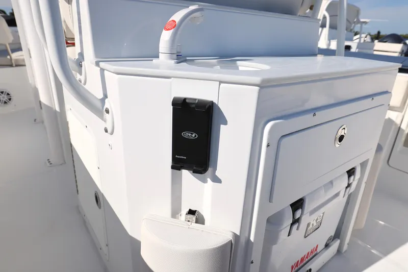 Slide: The Image of 2026 Sea Hunt Ultra 245 SE boat interior with storage and Yamaha cooler. - 19