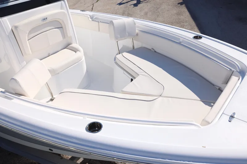Slide: The Image of 2026 Sea Hunt Ultra 245 SE boat interior with white cushioned seating. - 2