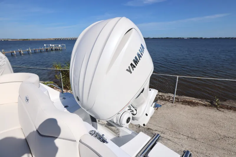 Slide: The Image of 2026 Sea Hunt Ultra 245 SE boat with Yamaha outboard motor by the water. - 21