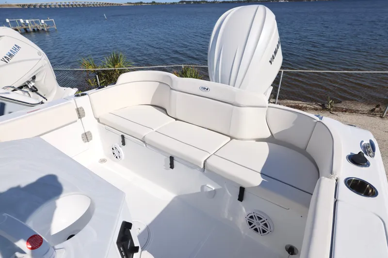 Slide: The Image of 2026 Sea Hunt Ultra 245 SE boat interior with Yamaha engine by the water. - 5