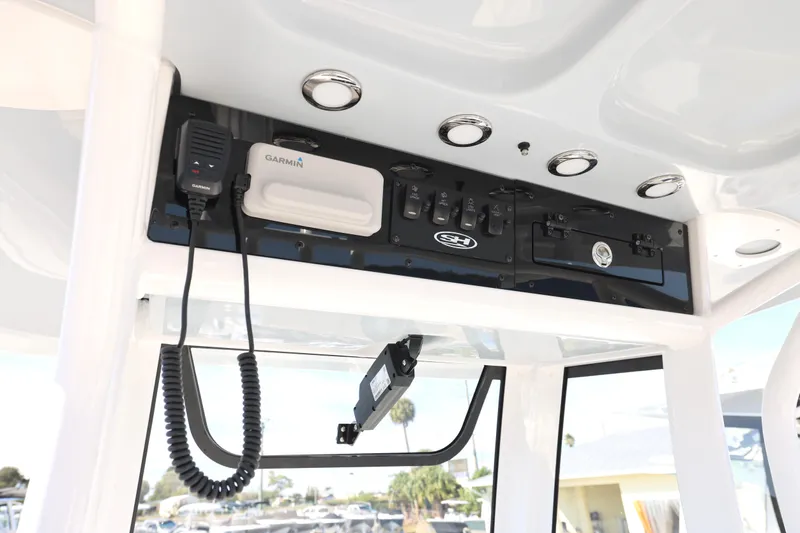 Slide: The Image of 2026 Sea Hunt Ultra 245 SE boat console with Garmin equipment and controls. - 7