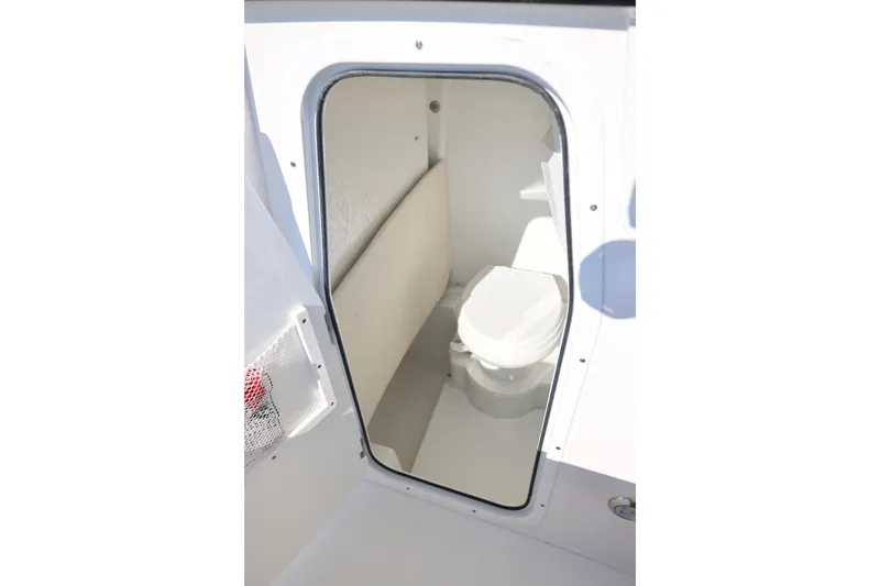 Slide: The Image of 2026 Sea Hunt Ultra 245 SE boat interior with compact marine toilet. - 9