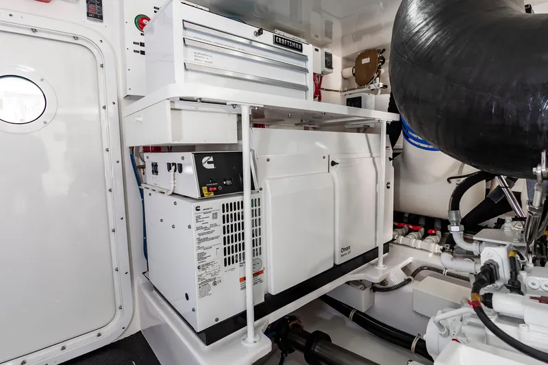 Slide: The Image of Engine room of 2024 Viking 72 Convertible yacht with Onan generator and Craftsman toolbox. - 103