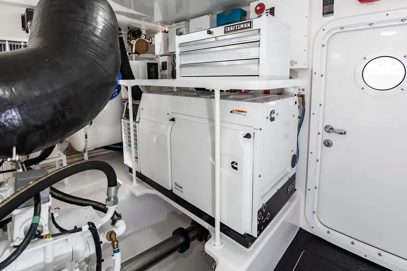 Slide: The Image of Engine room of 2024 Viking 72 Convertible yacht with Craftsman toolbox and Cummins generator. - 104