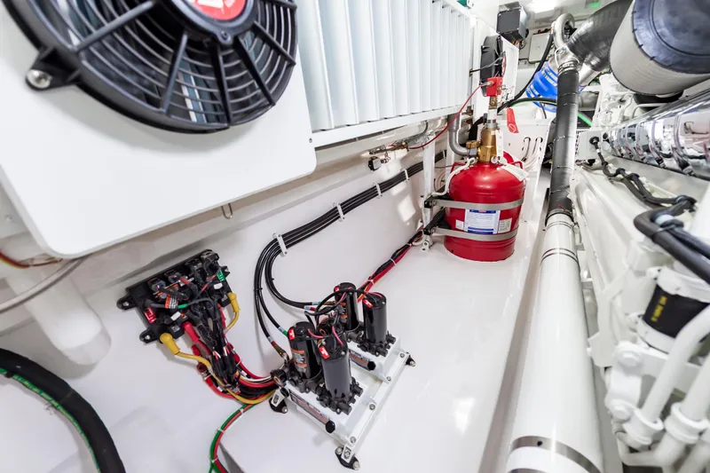 Slide: The Image of Engine room of 2024 Viking 72 Convertible yacht, showcasing wiring and fire suppression system. - 109